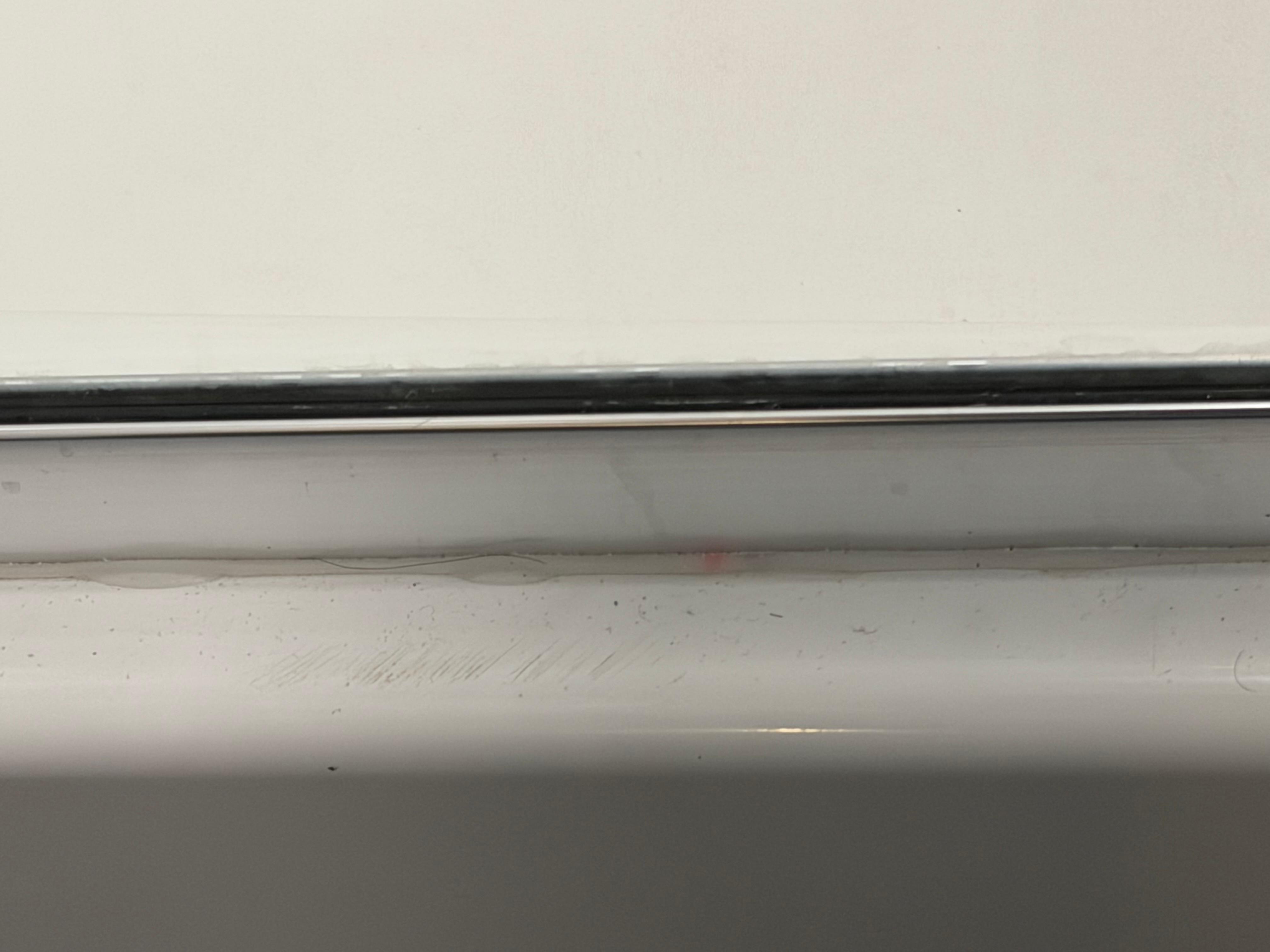 Pink mold starting to grow along shower.