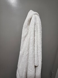 Dirty towel left behind door