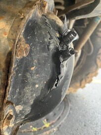 Broken bolts extending through the rear differential cover.