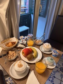 Breakfast by window on cafe table in Room.