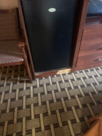 Damaged furniture that holds refrigerator
