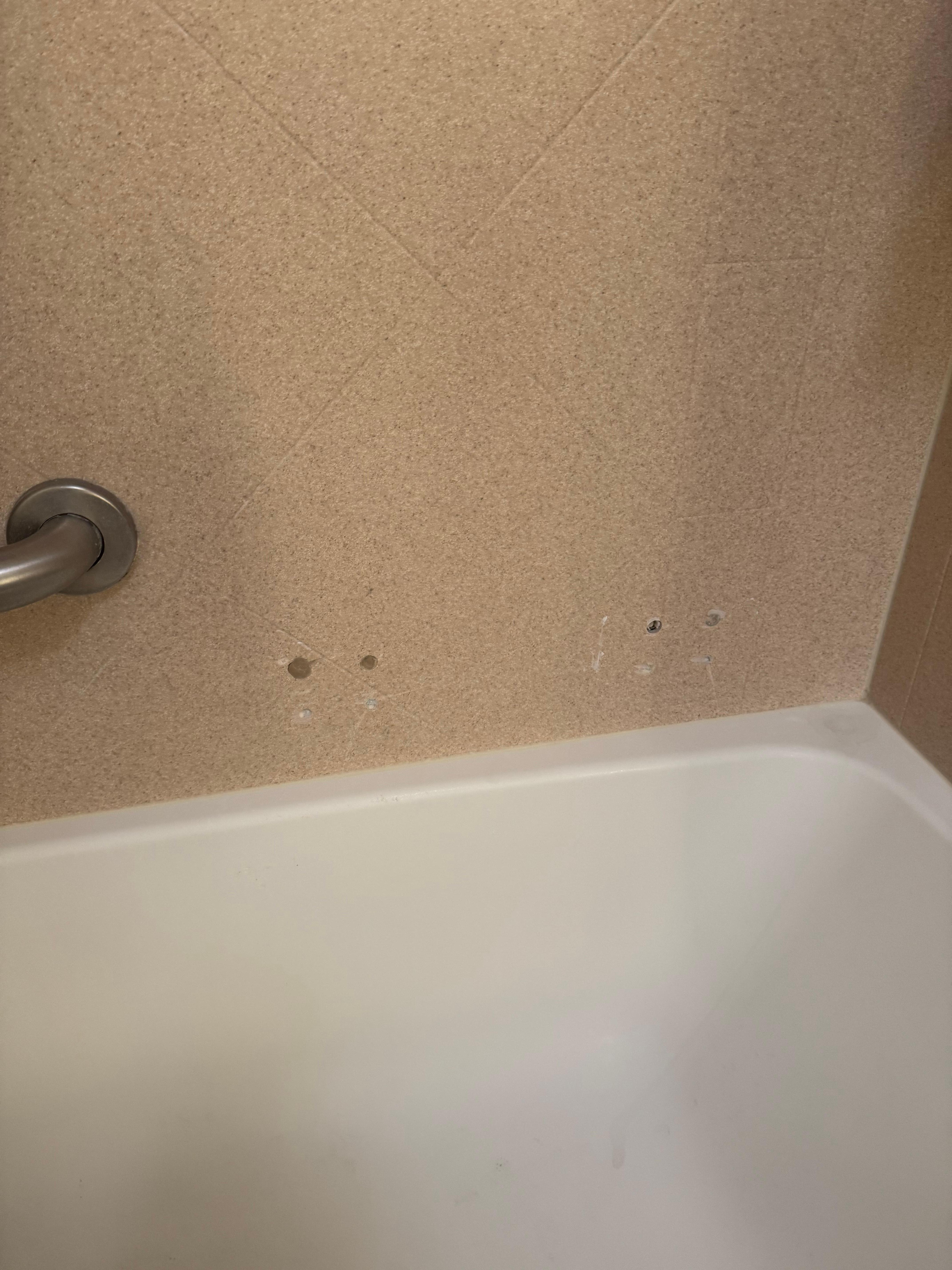 Wholes in the bathtub wall 