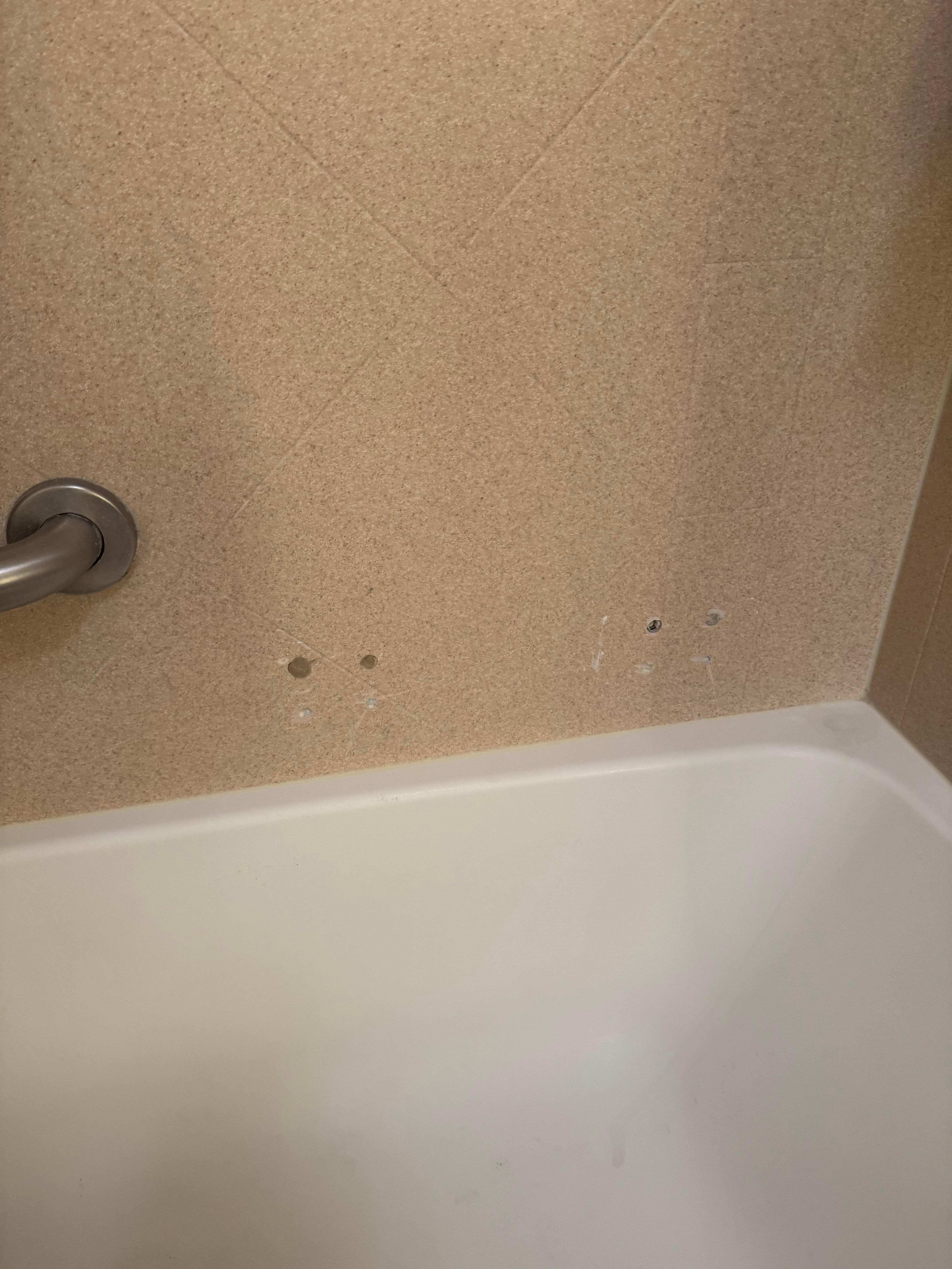 Wholes in the bathtub wall 