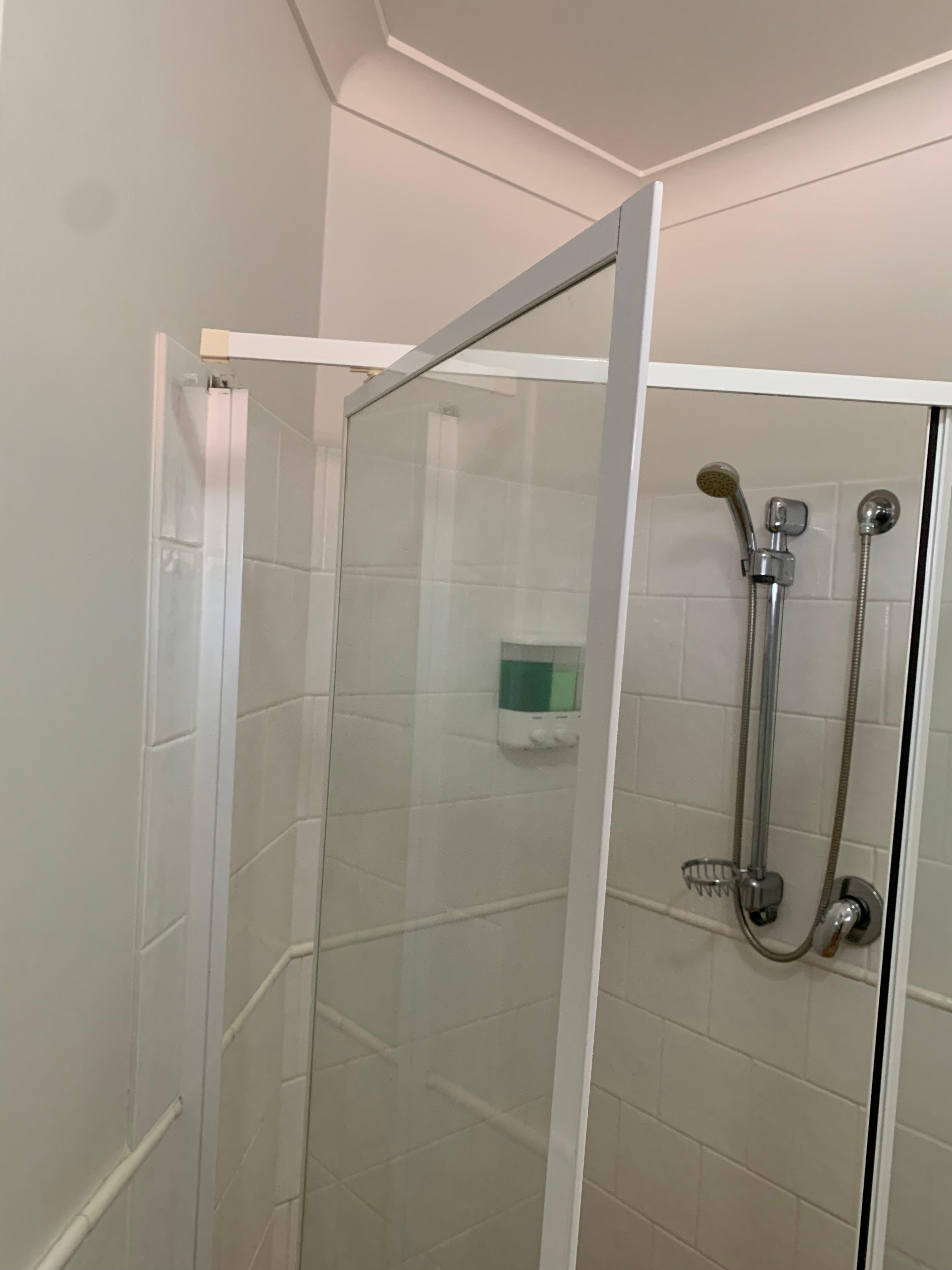 Shower door hanging off frame