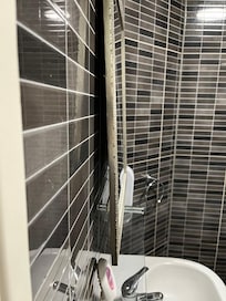 Bathroom mirror not screwed to wall properly
