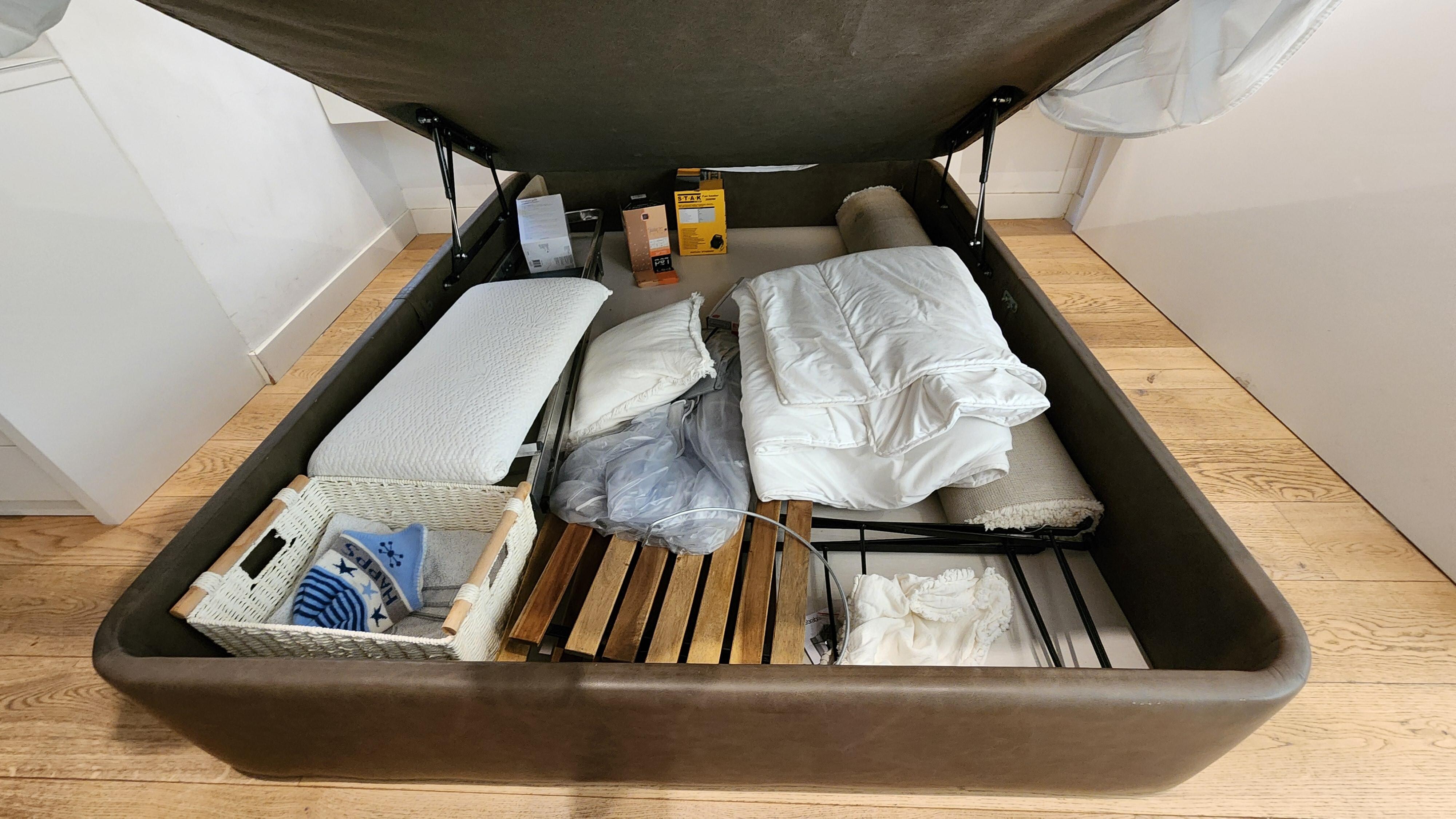 Storage area under bed and hidden by side boards. Who would think to lift a mattress to find storage?  