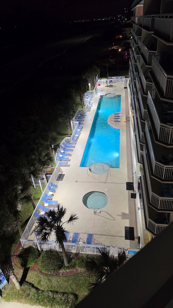 Night view from N605 balcony, looking at the South Tower's pool