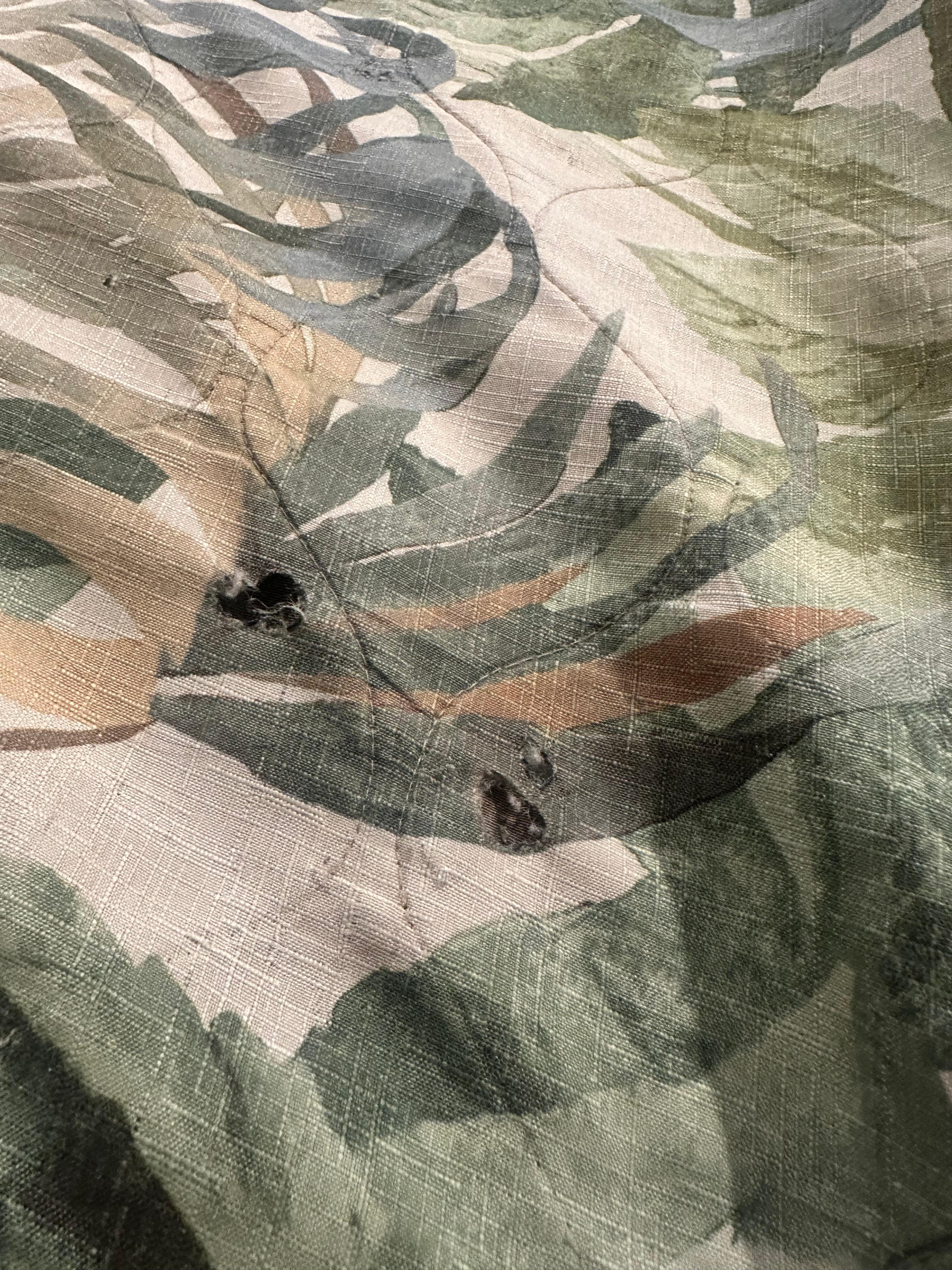 Cigarette burn holes in the blanket