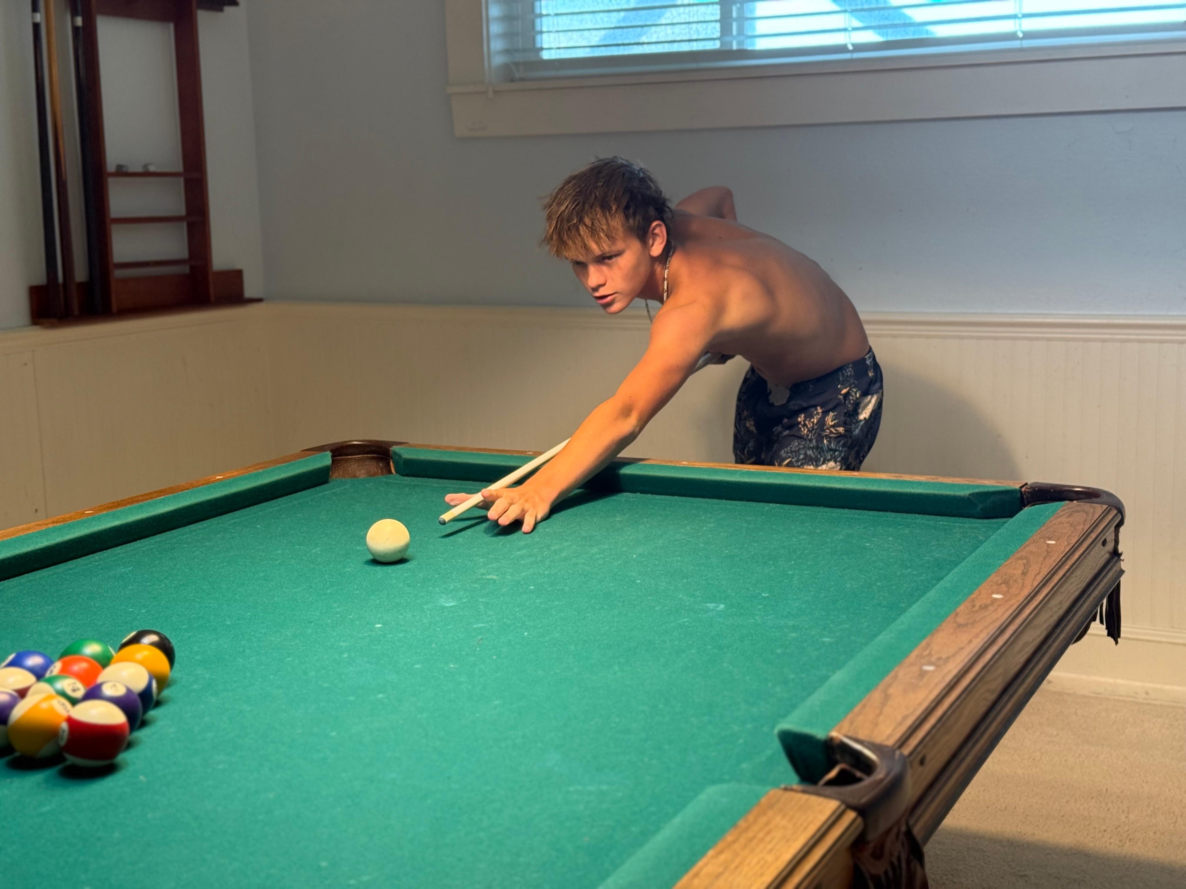 The boys enjoyed playing pool. 
