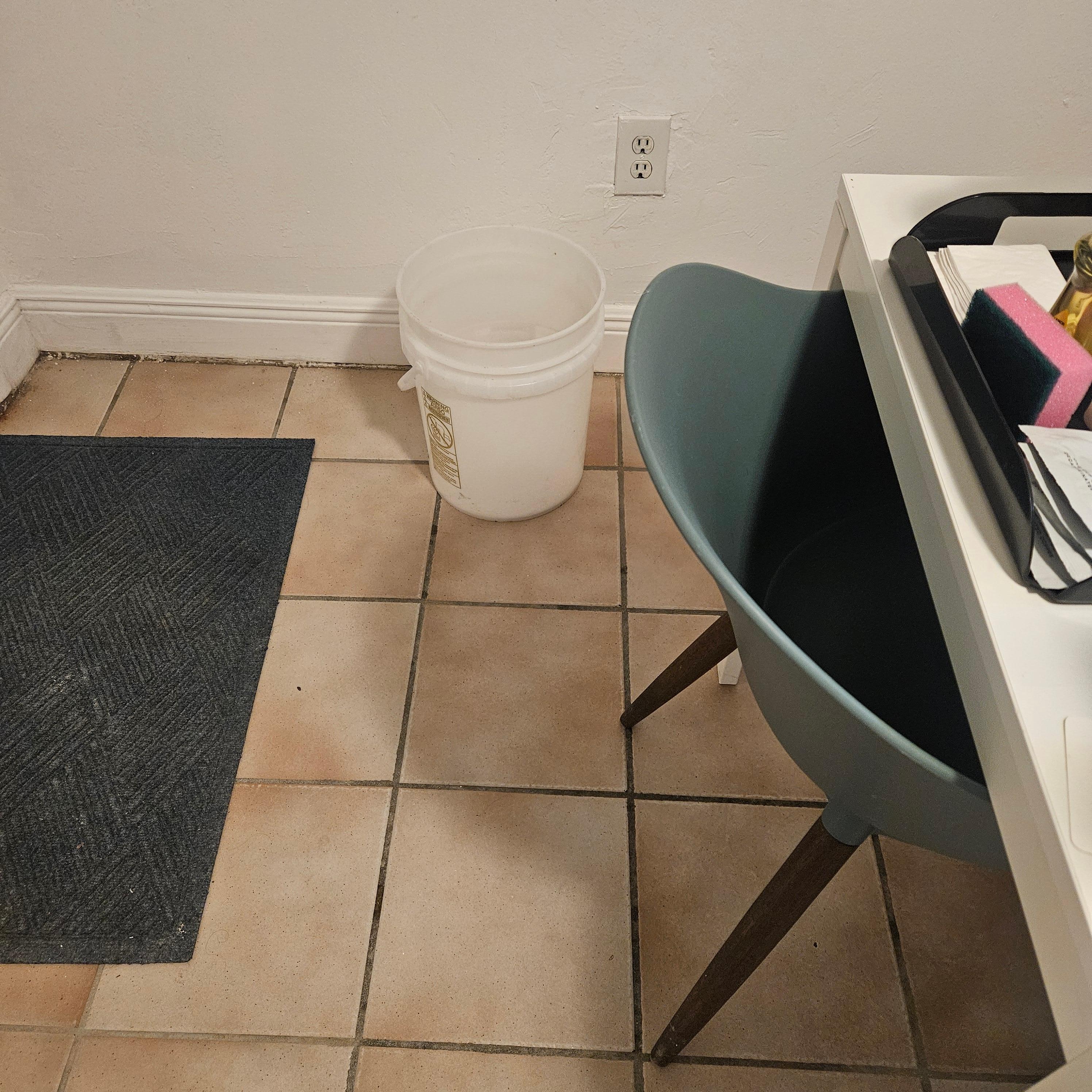 Bucket left in the room after being used to unclog toilet....