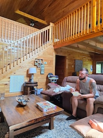 Family time against beautiful stairway to onus bedroom and arcade.
