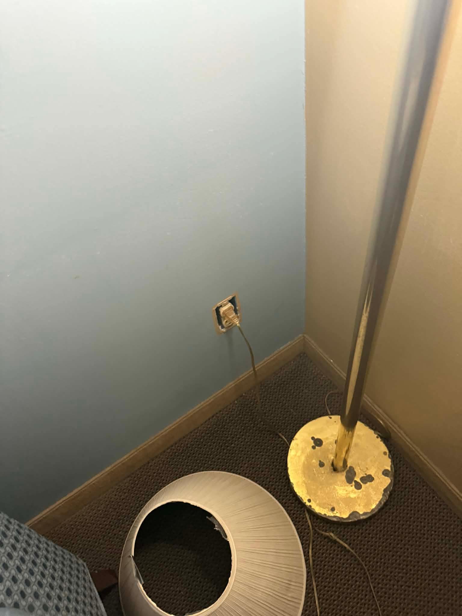 Broken outlet and shade was broken placed next to lamp
