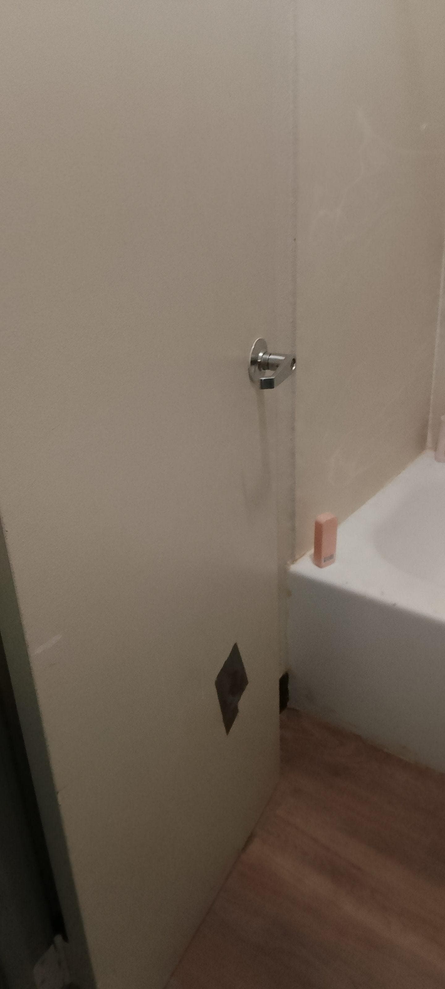 Bathroom door hole fixed with duct tape. 