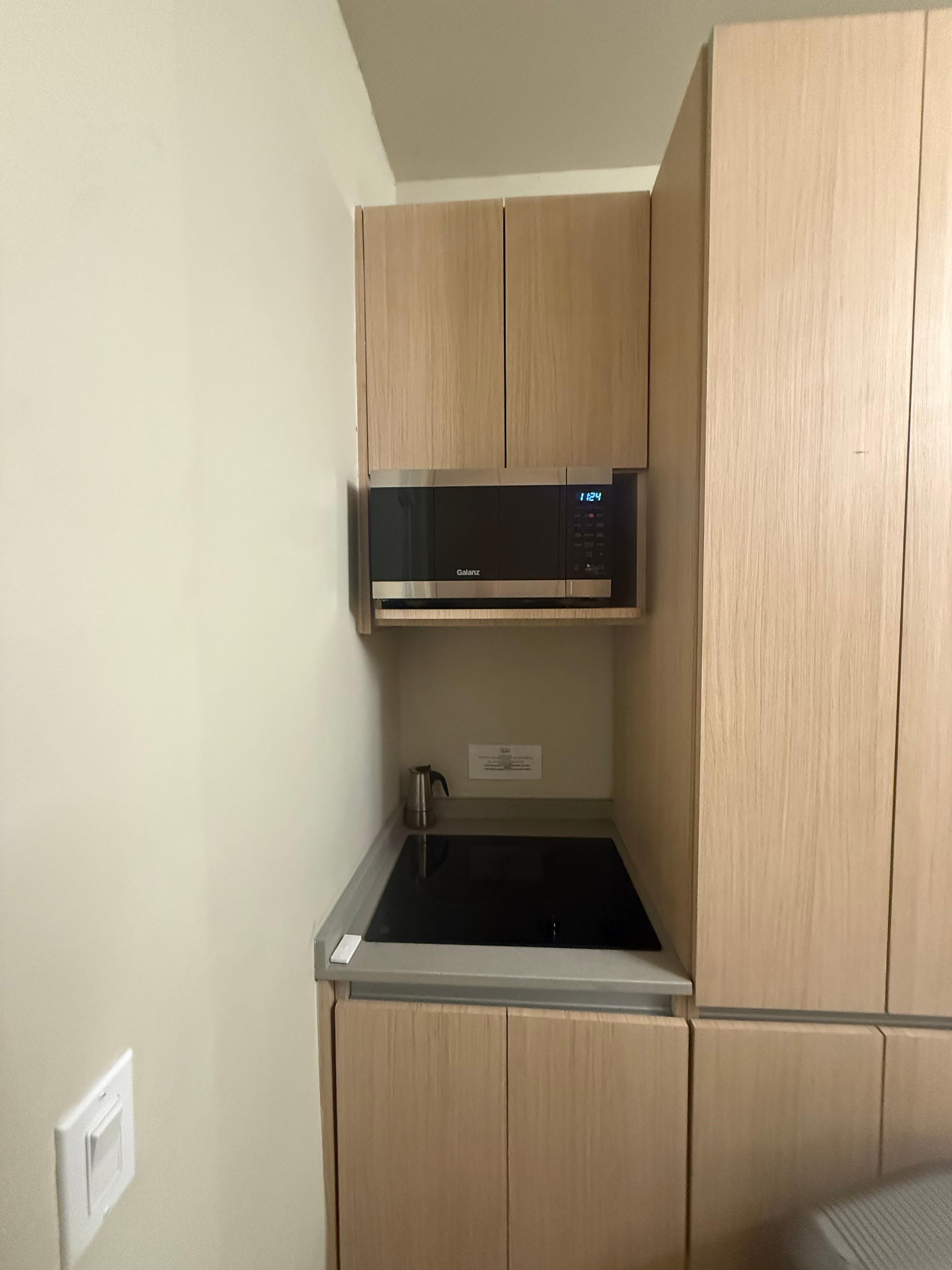 This is the stove top and microwave in the kitchen.