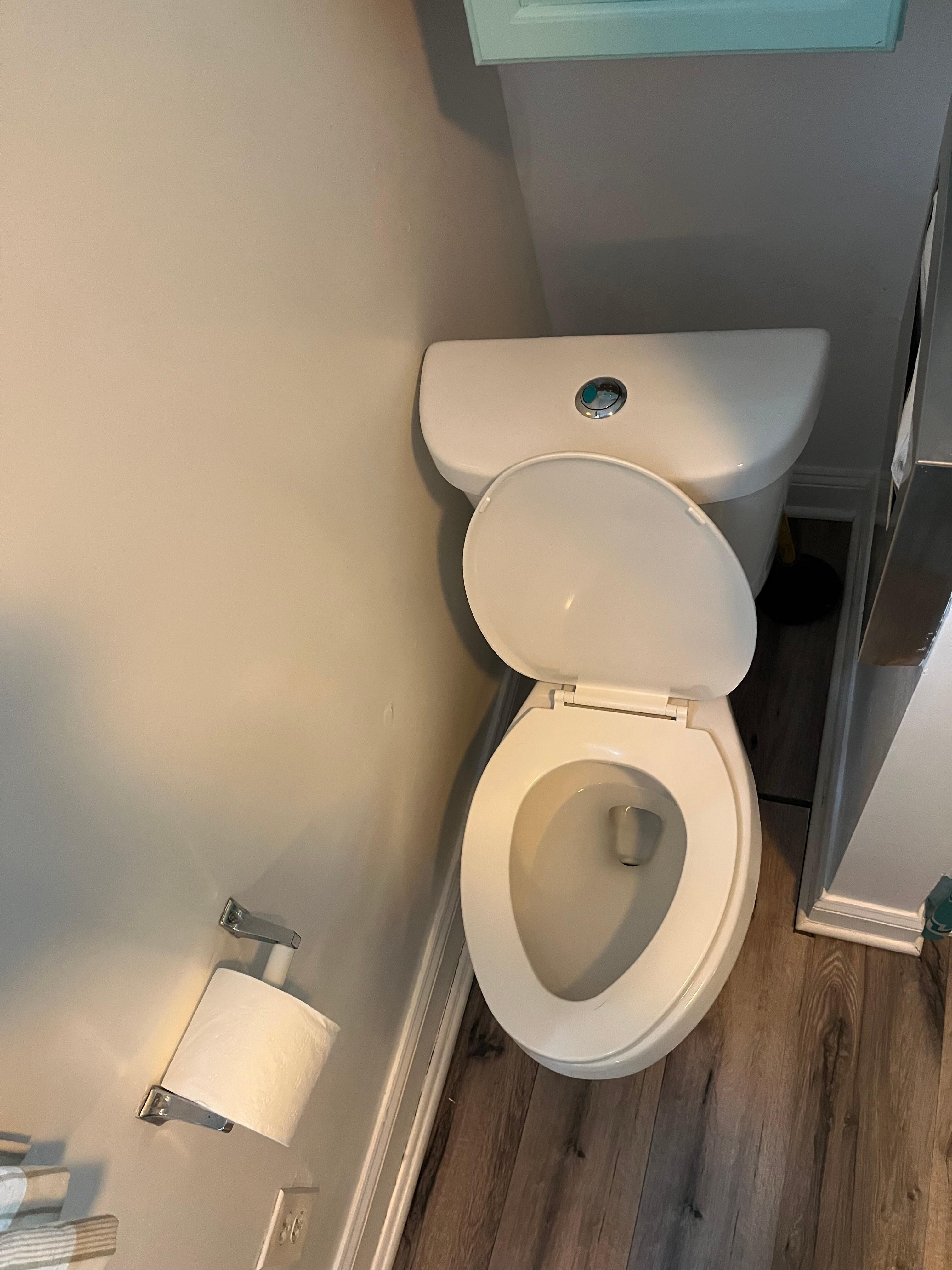 Toilet wedged against wall