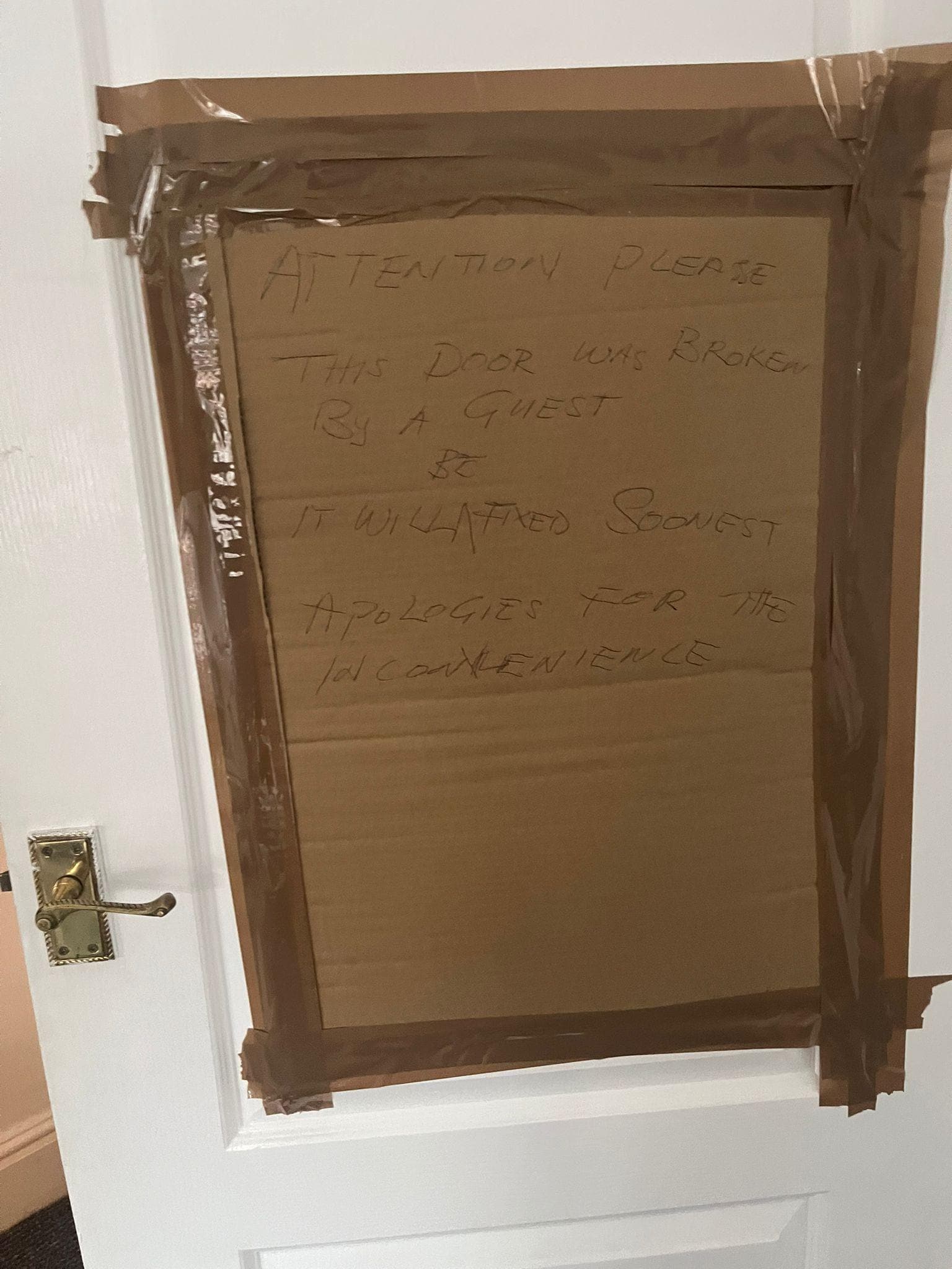 hole in door patched eith cardboard