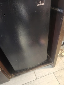 Around the side of the fridge was dirty. Fridge inside b looked clean but smelled