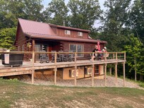 Outside view. Porch with 4 rockers and 6 seat dining table.There is also a pond with fire pit on the property. Beautiful grounds!