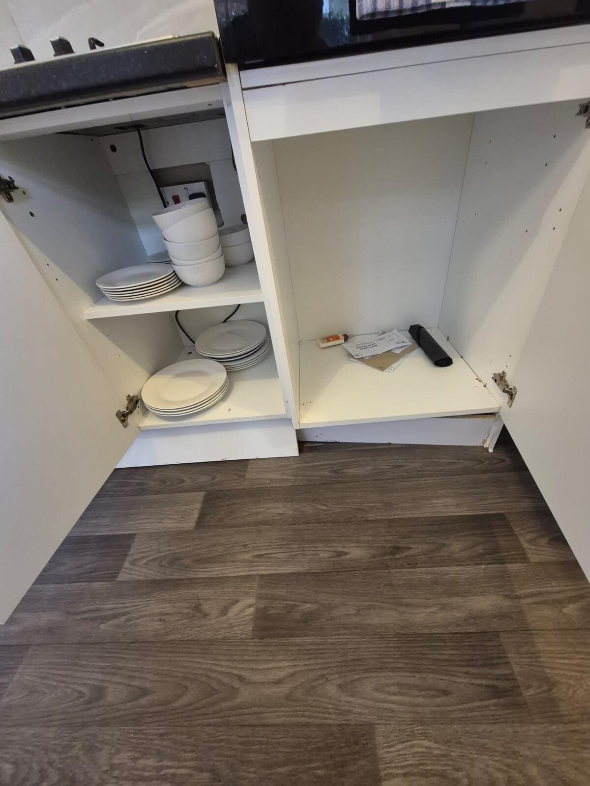 broken kitchen units with random rubbish and post