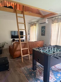 Game room and ladder to loft bedroom