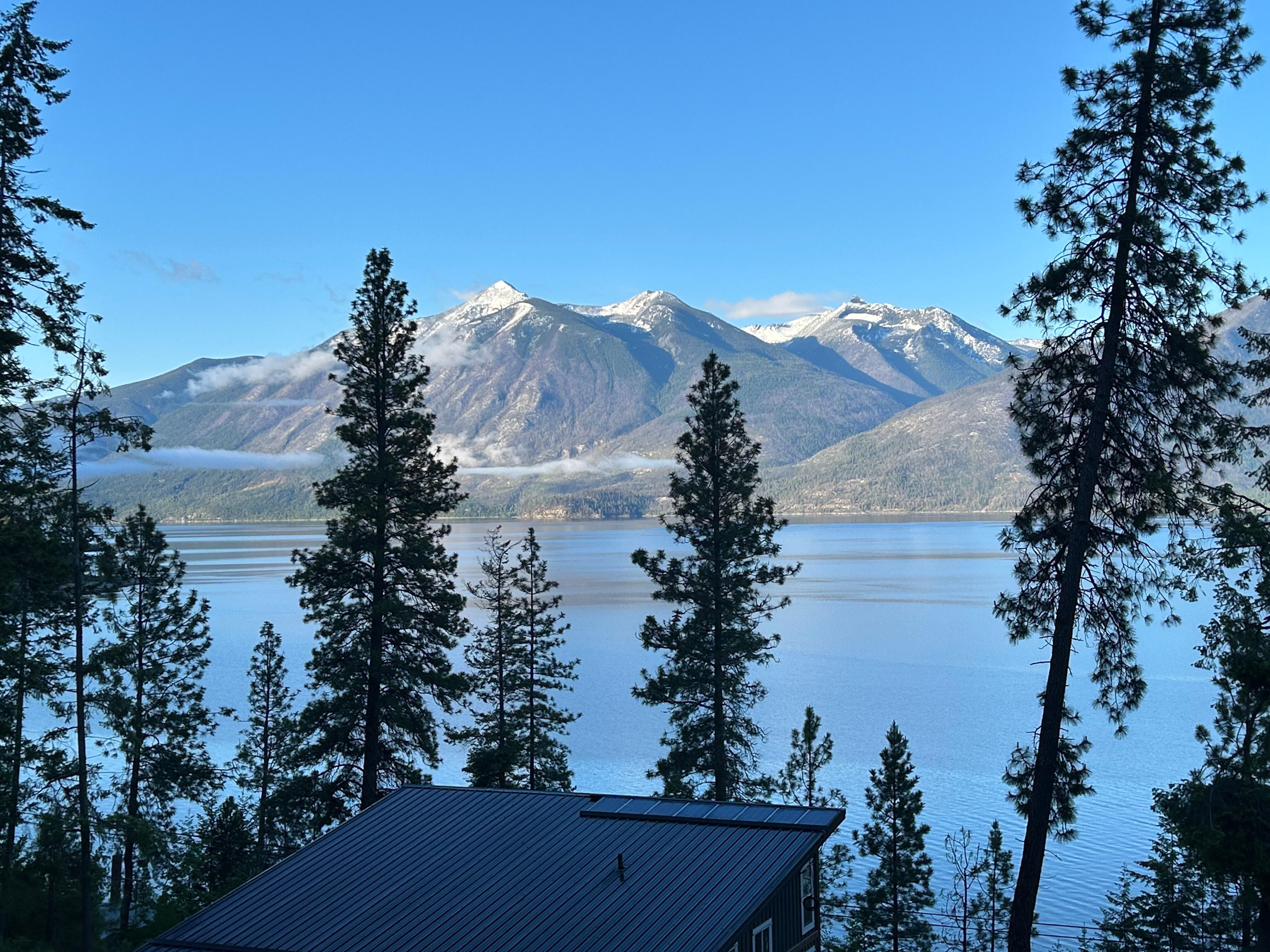 Morning sun on the  top of mountains across the lake