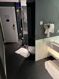 Separate shower and toilet area. Sink at right.