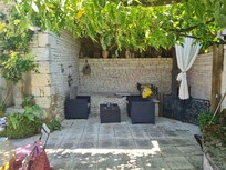 One outside area next to outdoor kitchen with gas bbq