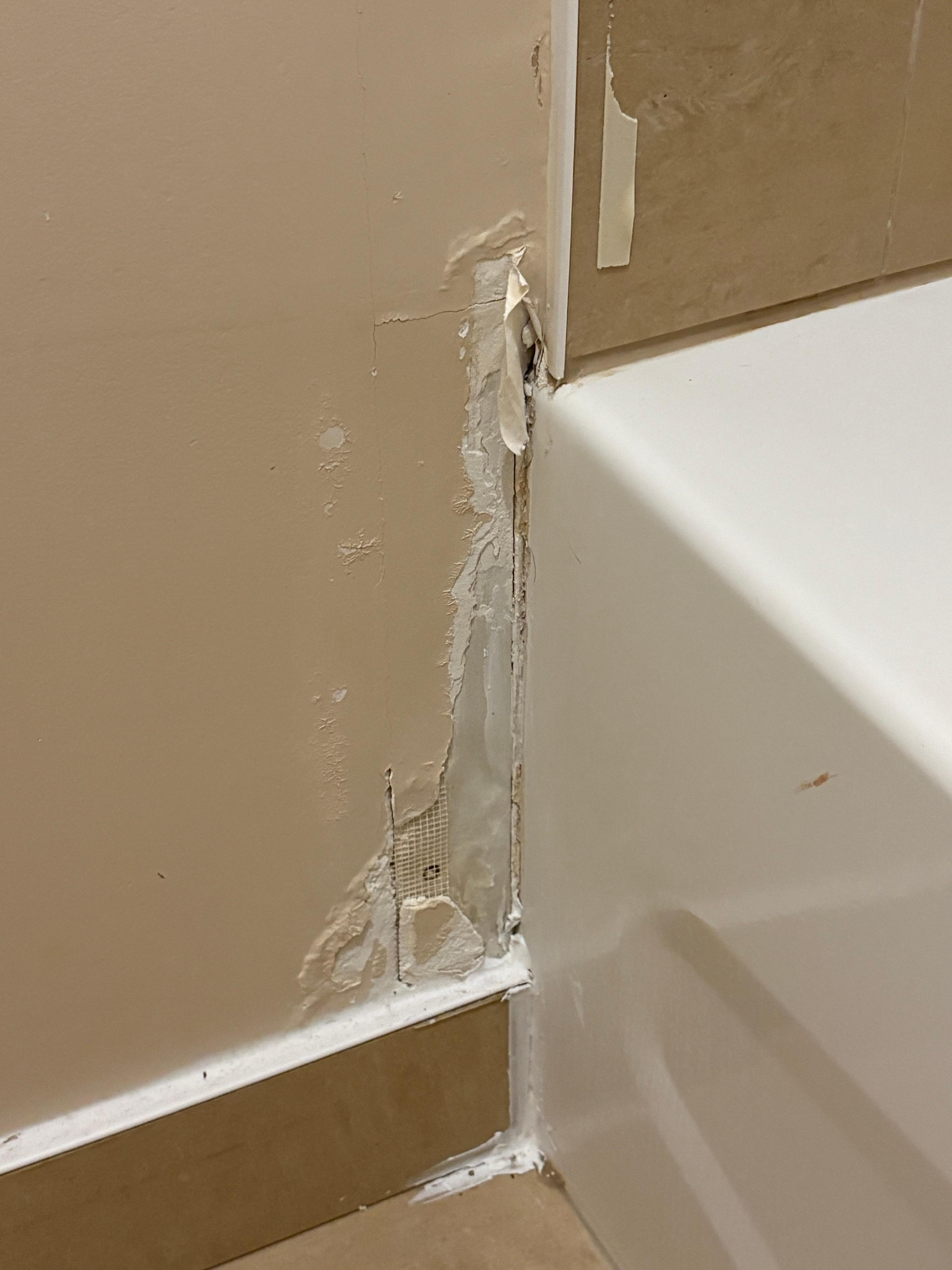 Damage beside bathtub
