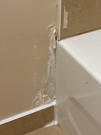 Damage beside bathtub