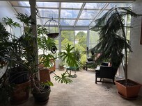 The sunroom was nice for relaxing and reading a book.