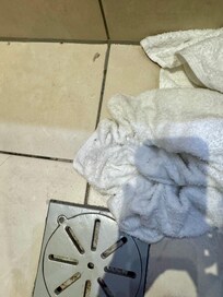Towels used to dry floors after each shower