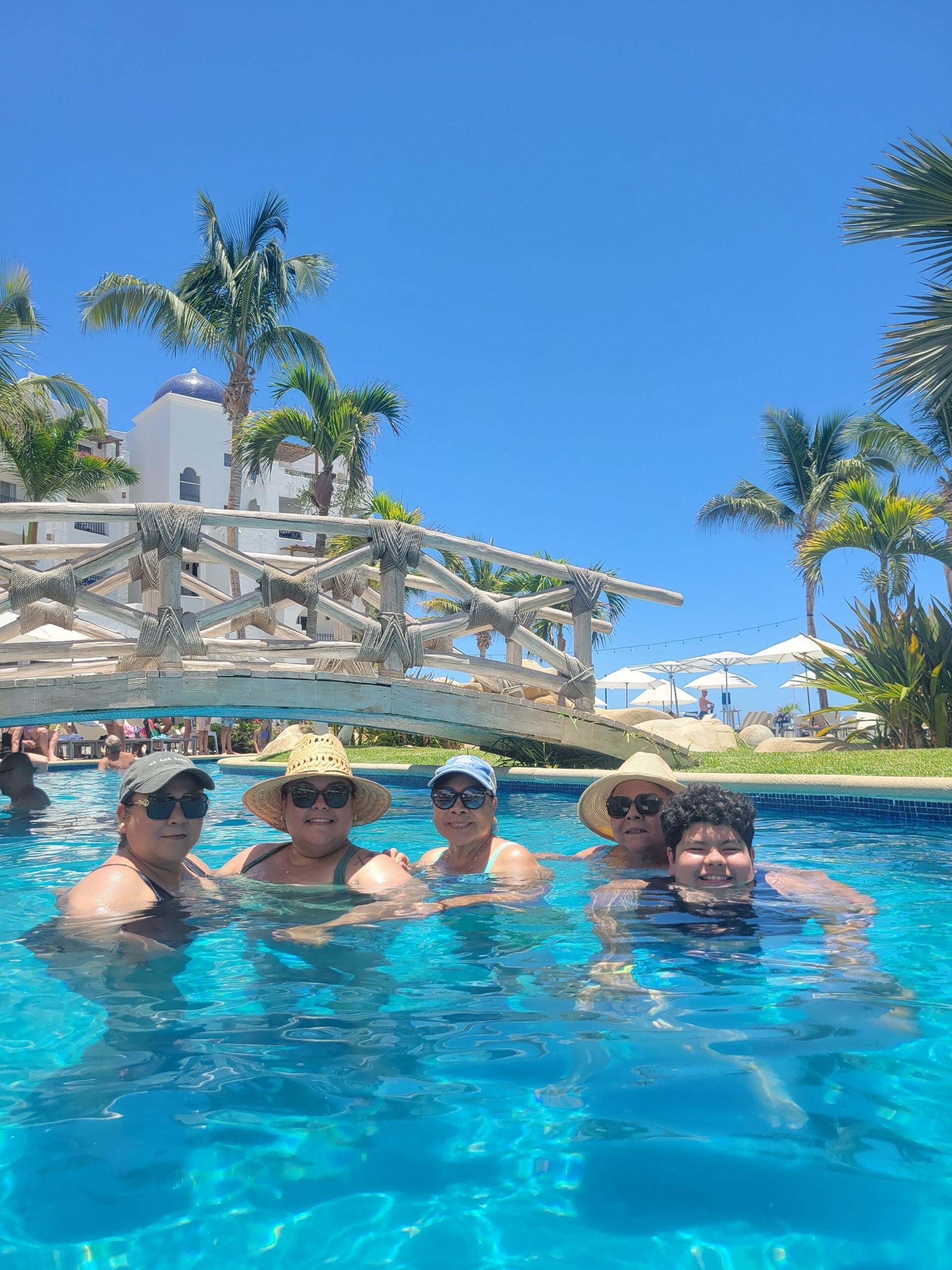 Enjoying the pool. Pool goes all around like a lazy river. Two waterfalls . 