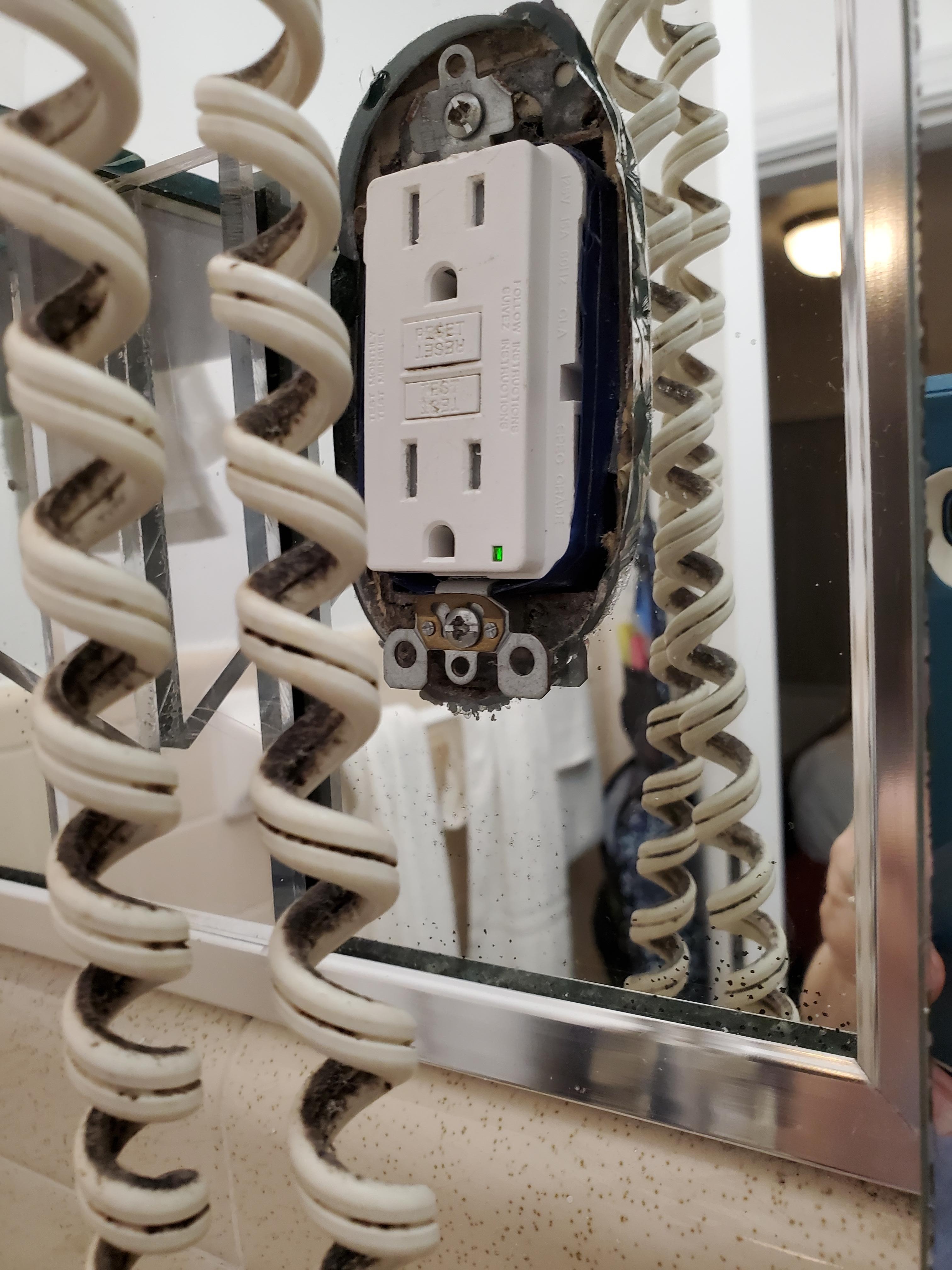 Mirror cutout for electrical outlet