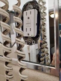 Mirror cutout for electrical outlet