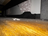 Under the bed had not bee cleaned in quite some time as evidenced by the shirt that was also quite dusty.