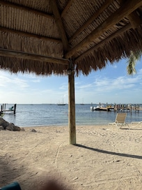 Shaded tikis have fans and lights, there’s charcoal grills and a rinsing shower.