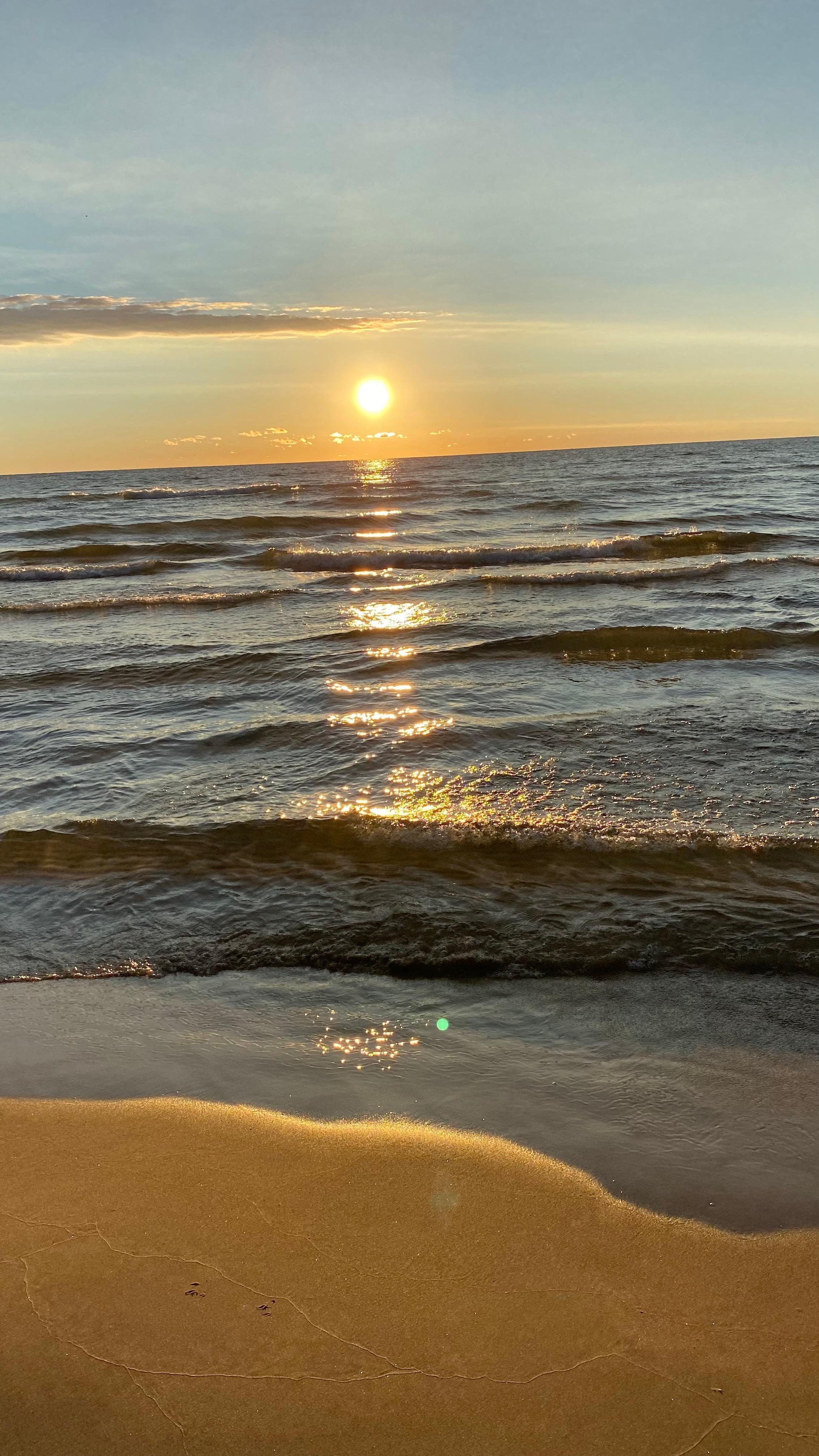 With steaming coffee mugs in hand, we enjoyed sunrises like this over Lake Michigan from the front deck. 