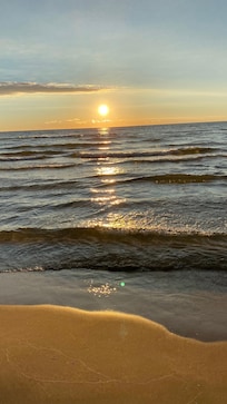 With steaming coffee mugs in hand, we enjoyed sunrises like this over Lake Michigan from the front deck.