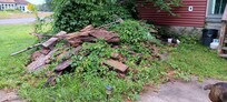 Pile of old construction wood. Been there a while because of weeds.