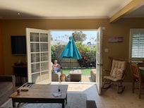 View out the back french doors with a partial view of the ocean.