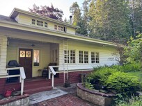 The sweet backyard, with its water feature and garden, led to charming forest paths with bridges over the creek that led to the ocean.