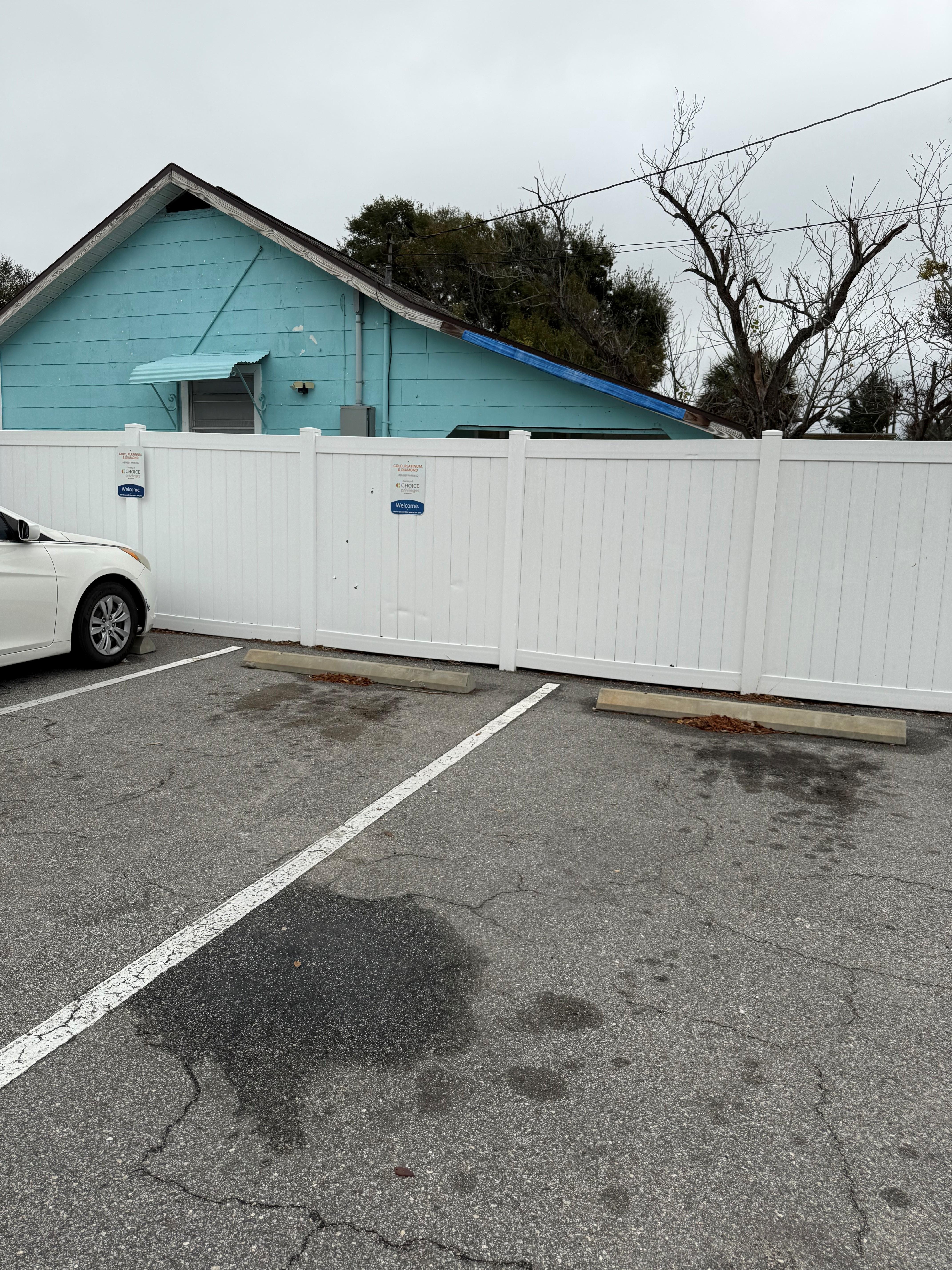 Showing the wall where you park your car and see the home on the other side.