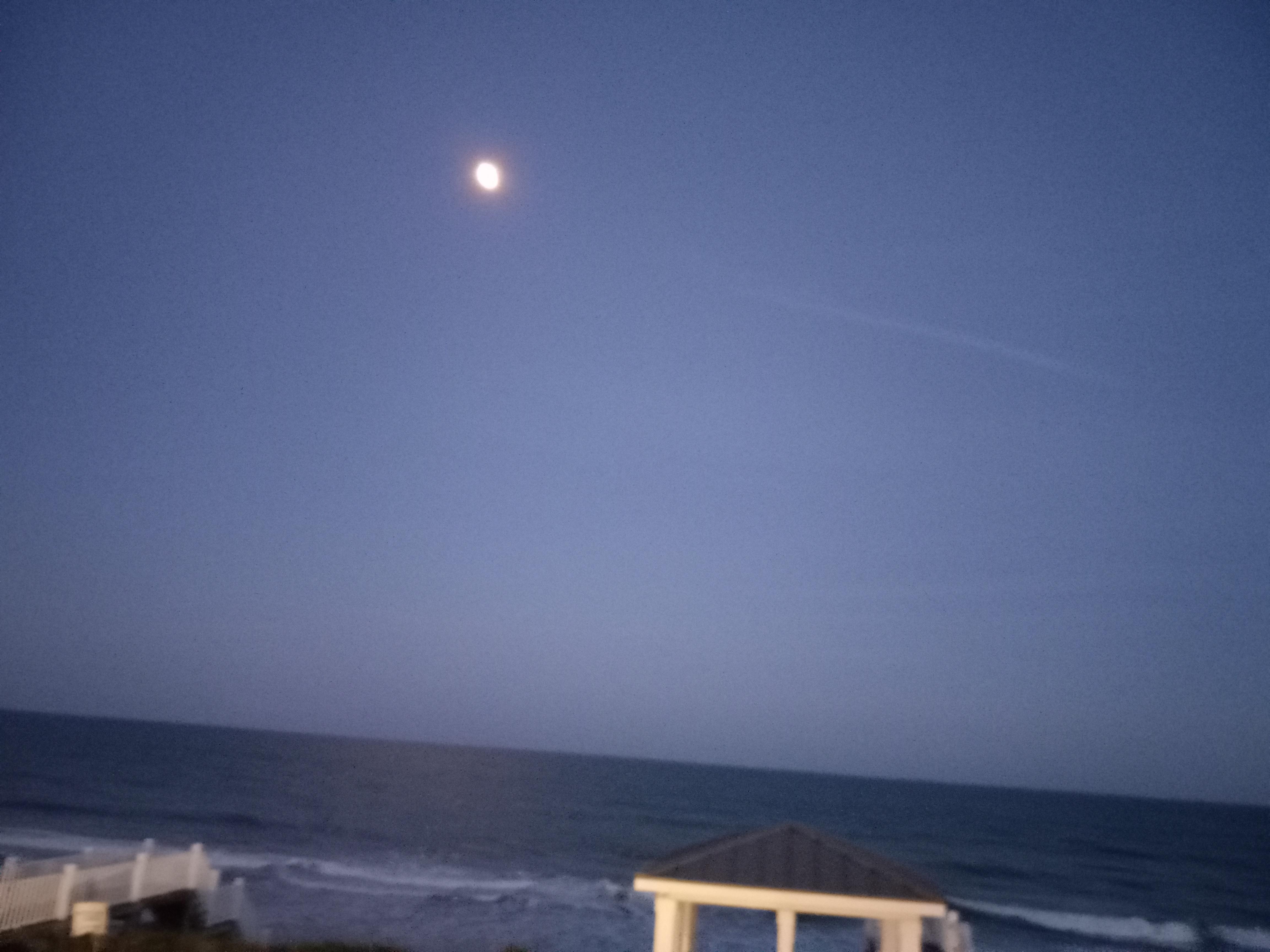 Full moon over the ocean.