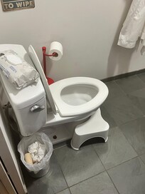 Bathroom trash left and toilet unclean