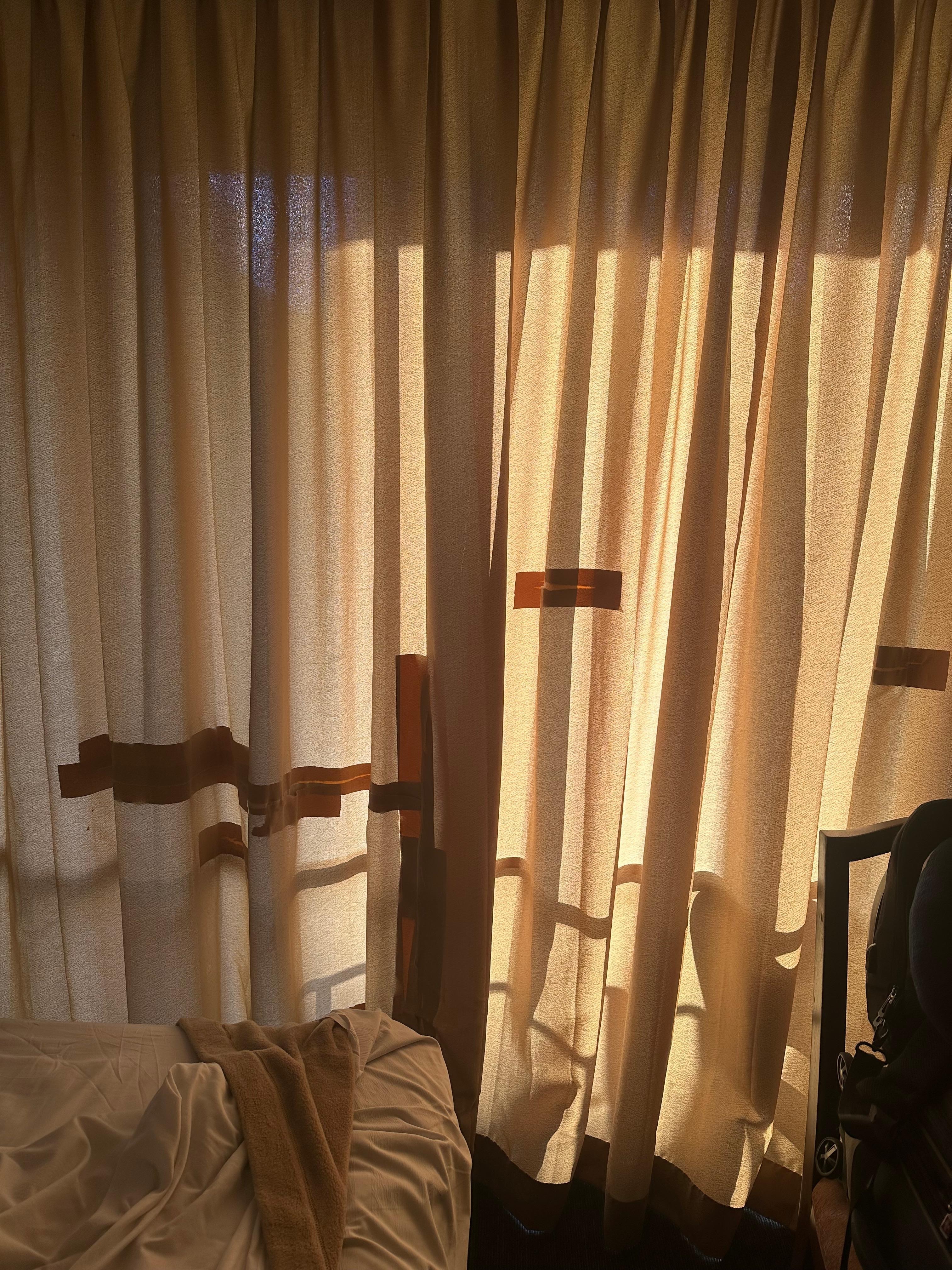 The curtain has been taped from the outside so it can’t be seen directly from the inside of the room. 