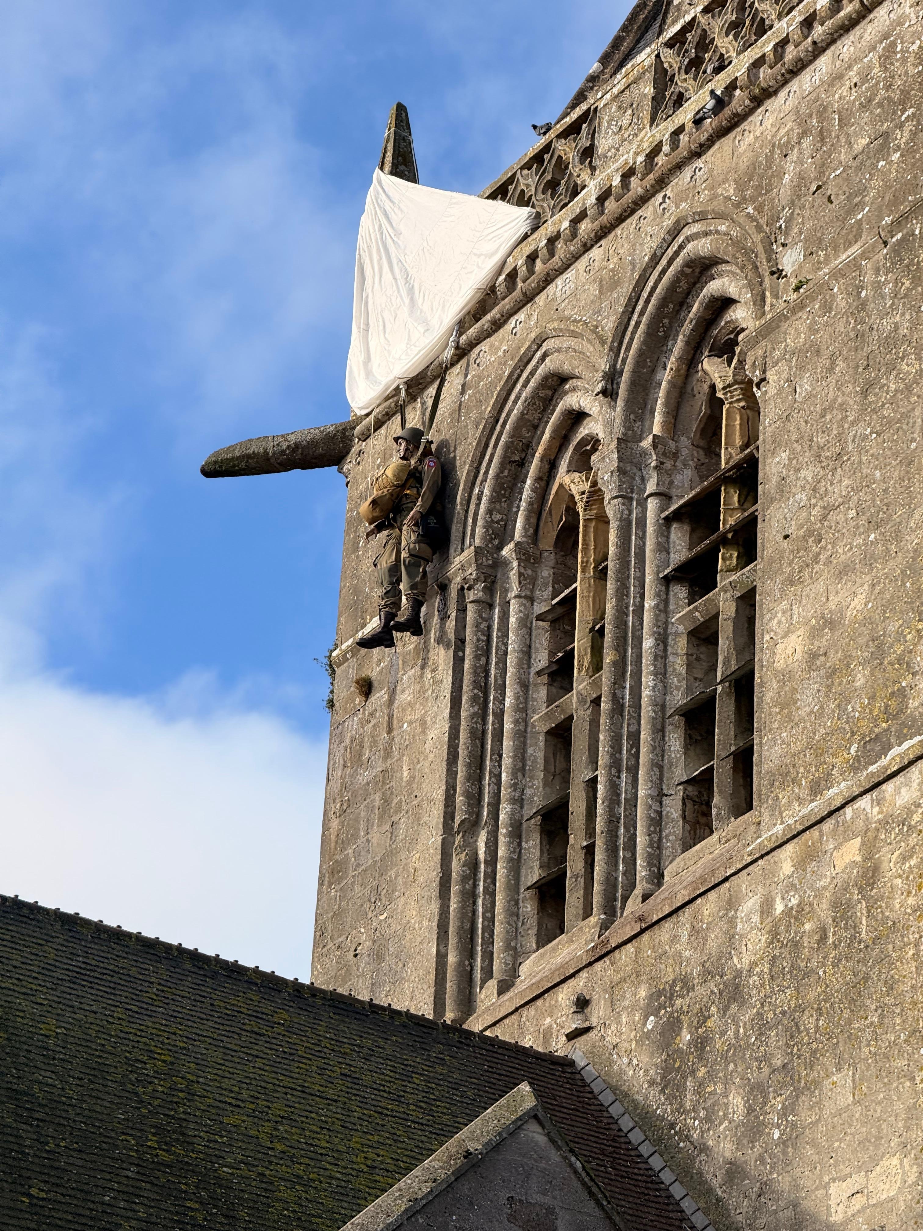 Paratrooper who landed on a steeple. He played dead until Germans realized he wasn’t 