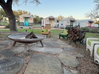 Cabins and partial view of fire pit with seating area.