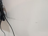 No paint on walls shows scuffs from TV