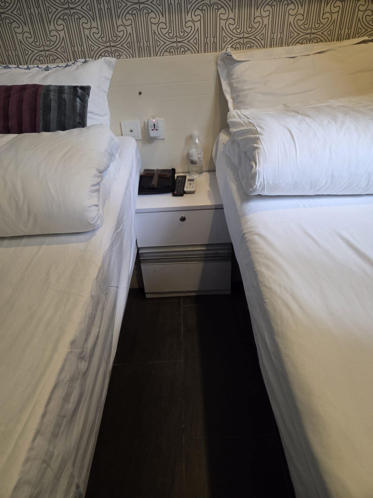 I stat a two single bed room. It's plenty space under the bed for large suit case.