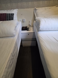 I stat a two single bed room. It's plenty space under the bed for large suit case.